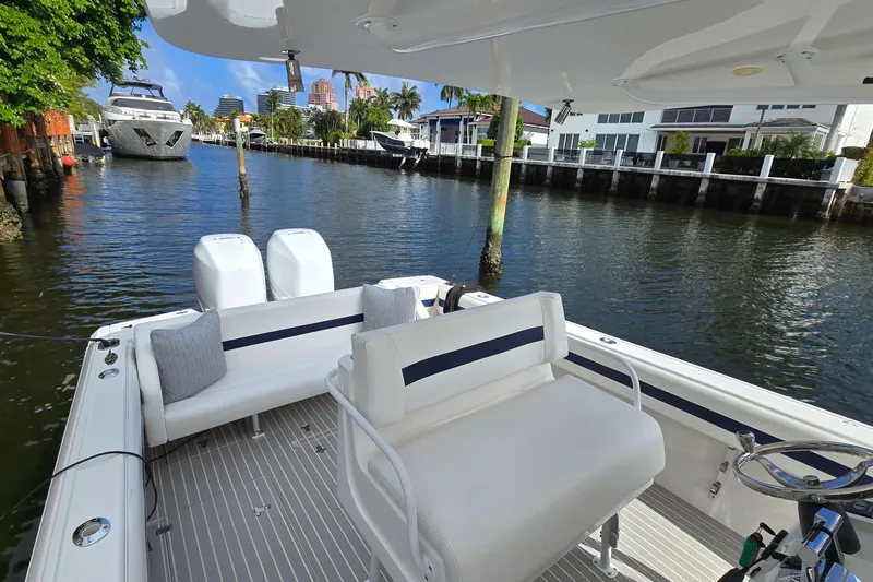 Slide: The Image of 2007 Intrepid 323 Open boat docked in a scenic waterfront area. - 4