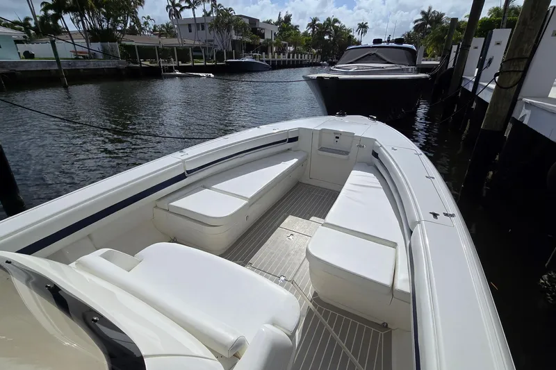 Slide: The Image of 2007 Intrepid 323 Open boat with spacious seating, docked in a serene waterfront setting. - 5