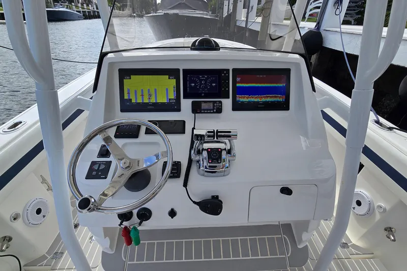 Slide: The Image of 2007 Intrepid 323 Open boat dashboard with steering wheel and electronic displays. - 6