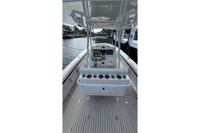 Slide: The Image of 2007 Intrepid 323 Open boat interior with steering console and rod holders. - 7