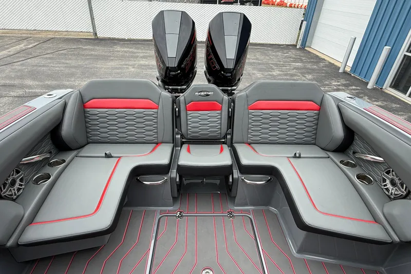 Slide: The Image of 2025 Sunsation 32 CCX boat interior with gray and red seating, dual engines, and cup holders. - 11