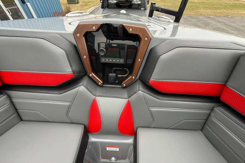 Slide: The Image of Interior of 2025 Sunsation 32 CCX boat with gray and red seating and audio controls. - 15