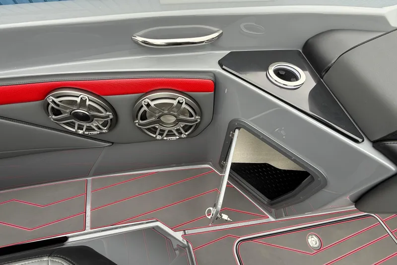 Slide: The Image of 2025 Sunsation 32 CCX boat interior with speakers, cup holder, and red accents. - 19
