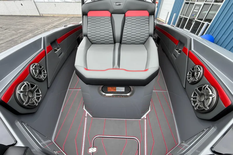 Slide: The Image of 2025 Sunsation 32 CCX boat interior with gray and red seating, advanced audio system. - 20