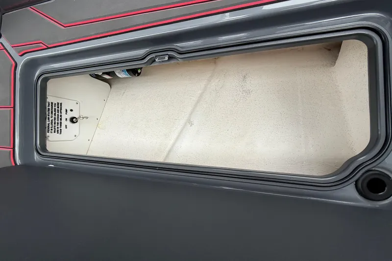 Slide: The Image of Storage compartment of 2025 Sunsation 32 CCX boat, featuring sleek design and red accents. - 23