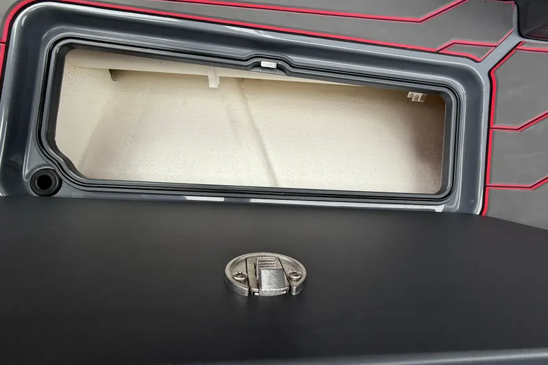 Slide: The Image of Storage compartment of 2025 Sunsation 32 CCX boat with sleek design and latch. - 24