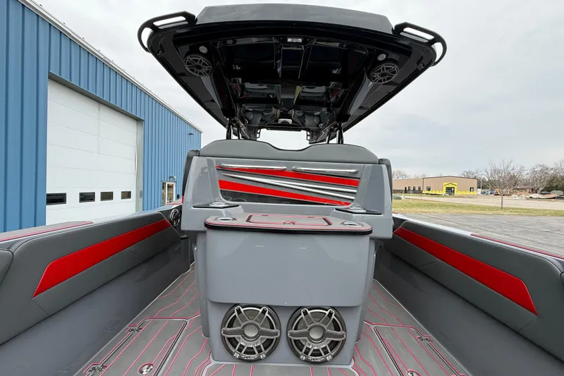 Slide: The Image of 2025 Sunsation 32 CCX boat interior with sleek gray and red design, featuring advanced audio system. - 25