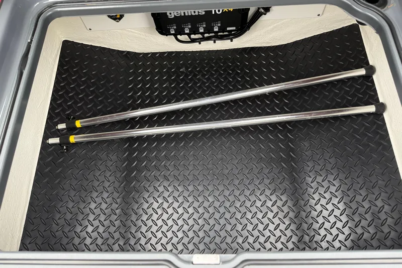 Slide: The Image of Storage compartment of 2025 Sunsation 32 CCX boat with diamond-patterned flooring and metal rods. - 26