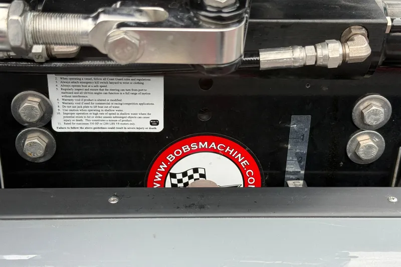 Slide: The Image of Close-up of mechanical components on a 2025 Sunsation 32 CCX boat, featuring safety instructions. - 28
