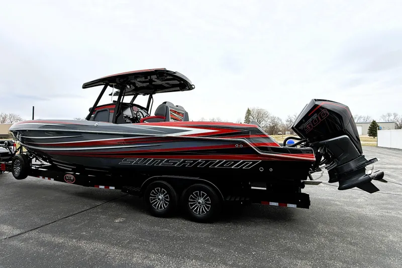 Slide: The Image of 2025 Sunsation 32 CCX boat with sleek design and powerful outboard engine on a trailer. - 3