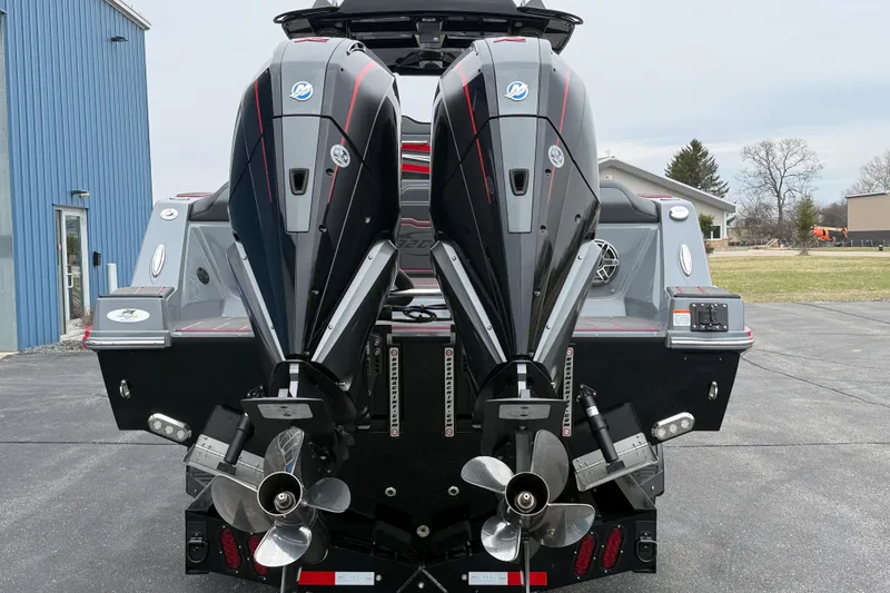 Slide: The Image of 2025 Sunsation 32 CCX boat with dual outboard engines, parked outdoors. - 6