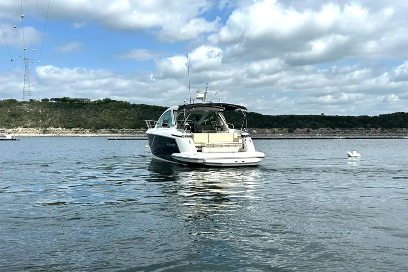Slide: The Image of 2017 Monterey 360 Sport Coupe on a serene lake under a cloudy sky. - 14