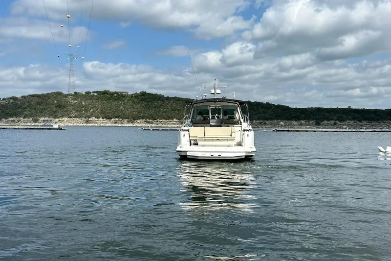 Slide: The Image of 2017 Monterey 360 Sport Coupe on a serene lake under a partly cloudy sky. - 15