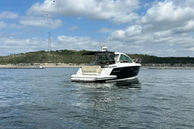Slide: The Image of 2017 Monterey 360 Sport Coupe on a scenic lake with cloudy sky backdrop. - 16