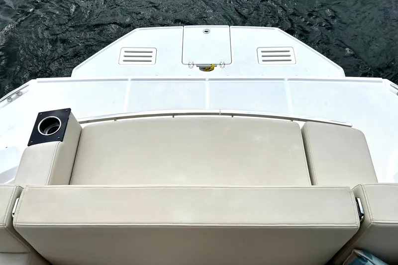 Slide: The Image of Rear view of a 2017 Monterey 360 Sport Coupe boat with beige seating and water backdrop. - 19