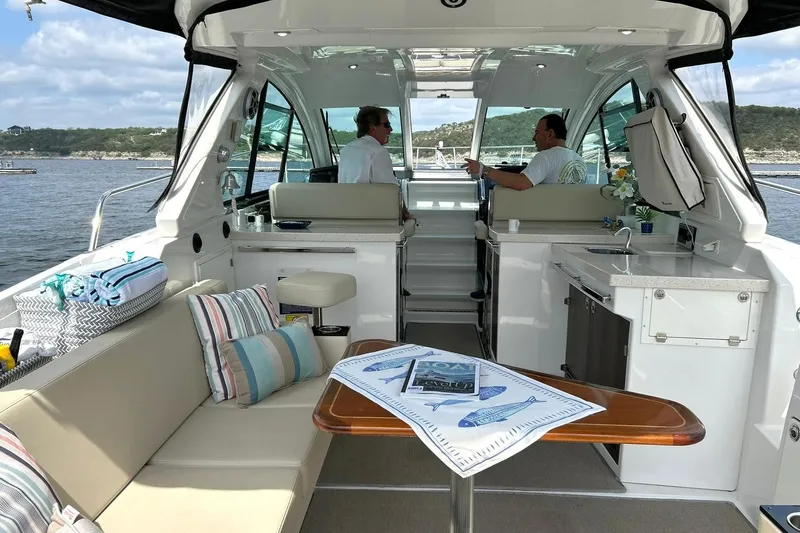 Slide: The Image of Interior of a 2017 Monterey 360 Sport Coupe yacht with seating and kitchenette. - 2