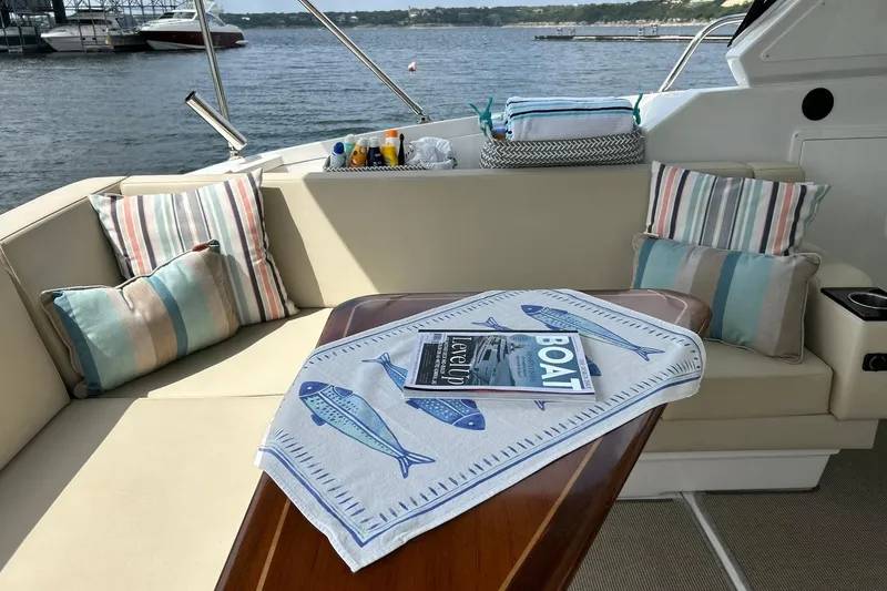 Slide: The Image of Luxurious seating area on a 2017 Monterey 360 Sport Coupe yacht with decorative pillows. - 23