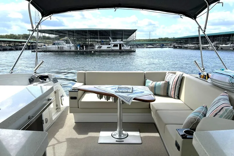 Slide: The Image of Luxurious 2017 Monterey 360 Sport Coupe interior with comfortable seating and scenic marina view. - 24