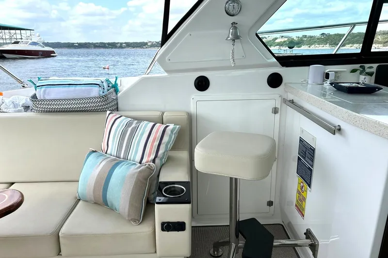 Slide: The Image of Interior of 2017 Monterey 360 Sport Coupe with seating, cushions, and lake view. - 27