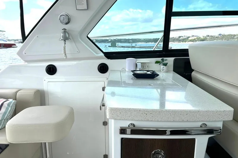Slide: The Image of Luxurious interior of a 2017 Monterey 360 Sport Coupe yacht with elegant seating and countertop. - 28