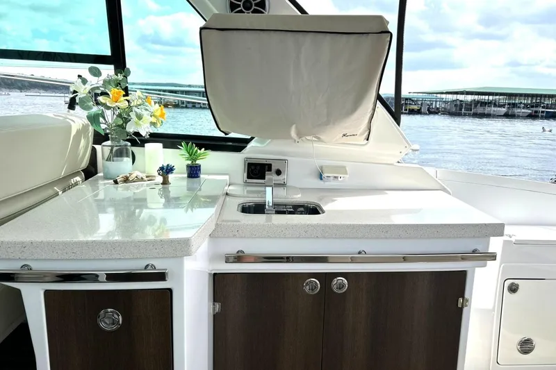 Slide: The Image of Interior of 2017 Monterey 360 Sport Coupe with kitchenette and lake view. - 29