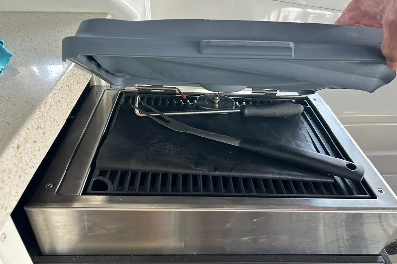 Slide: The Image of Outdoor grill on 2017 Monterey 360 Sport Coupe with utensils on top. - 32