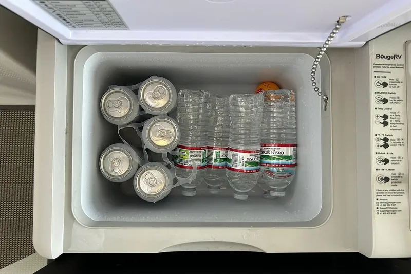 Slide: The Image of Cooler with soda cans and water bottles inside a 2017 Monterey 360 Sport Coupe. - 34