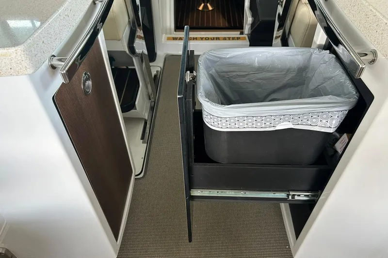 Slide: The Image of 2017 Monterey 360 Sport Coupe interior with pull-out trash bin in kitchen area. - 37