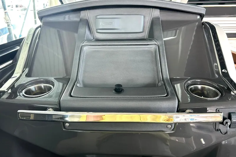 Slide: The Image of 2017 Monterey 360 Sport Coupe dashboard with cup holders and storage compartment. - 42