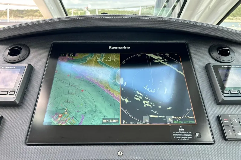 Slide: The Image of Dashboard of a 2017 Monterey 360 Sport Coupe with Raymarine navigation display. - 49