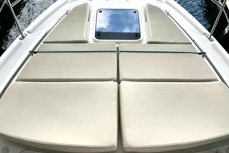Slide: The Image of Sunpad on 2017 Monterey 360 Sport Coupe boat, featuring beige cushions and a hatch. - 53