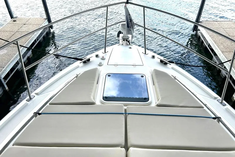 Slide: The Image of 2017 Monterey 360 Sport Coupe boat bow view at dock, featuring sleek design and sunpad. - 54
