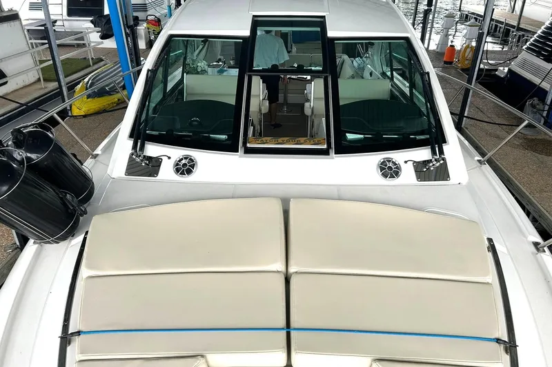 Slide: The Image of 2017 Monterey 360 Sport Coupe yacht with sunpad and sleek design in marina setting. - 55