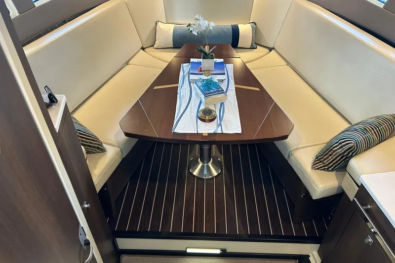 Slide: The Image of Luxurious interior of 2017 Monterey 360 Sport Coupe with elegant seating and table setup. - 58