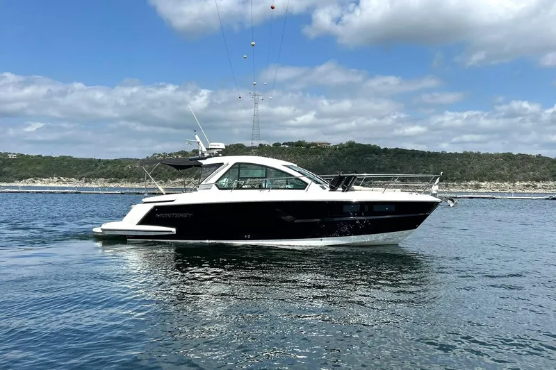 Slide: The Image of 2017 Monterey 360 Sport Coupe yacht cruising on a calm lake under a partly cloudy sky. - 6