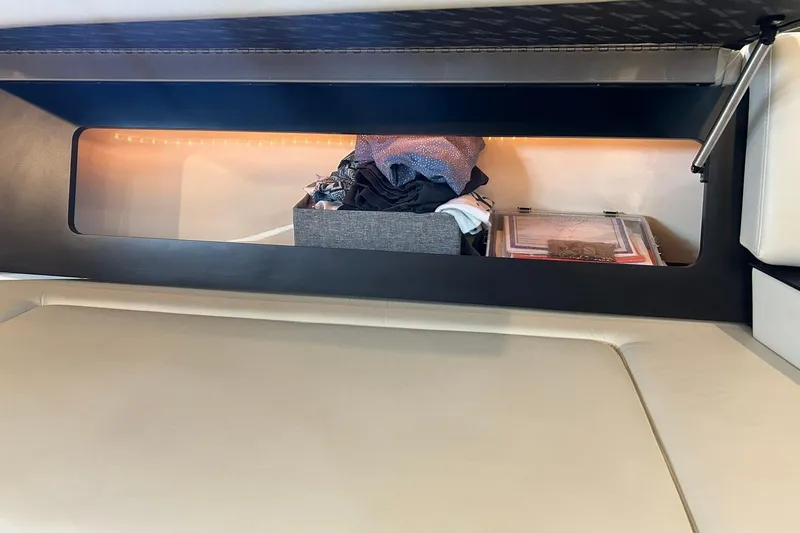 Slide: The Image of Storage compartment in a 2017 Monterey 360 Sport Coupe, containing clothes and documents. - 65