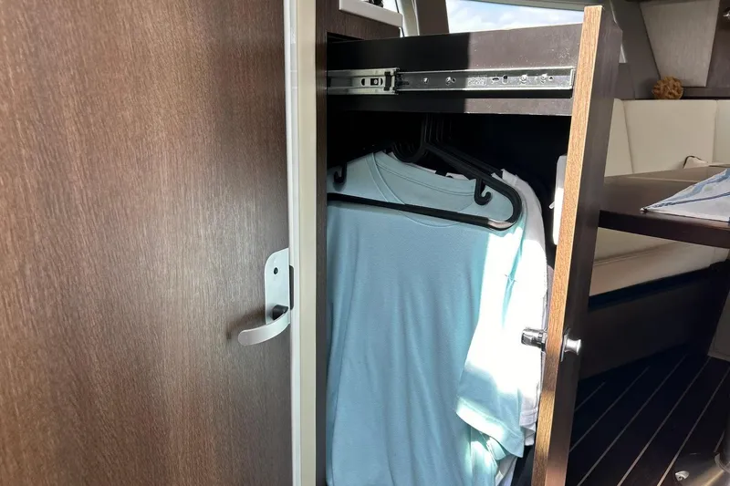 Slide: The Image of Closet inside 2017 Monterey 360 Sport Coupe yacht with hanging clothes. - 66