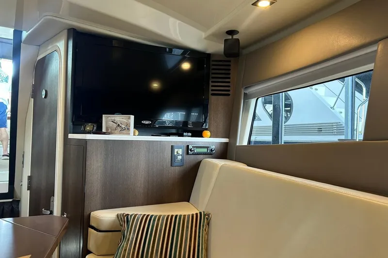 Slide: The Image of Interior of 2017 Monterey 360 Sport Coupe with TV, seating, and window view. - 68