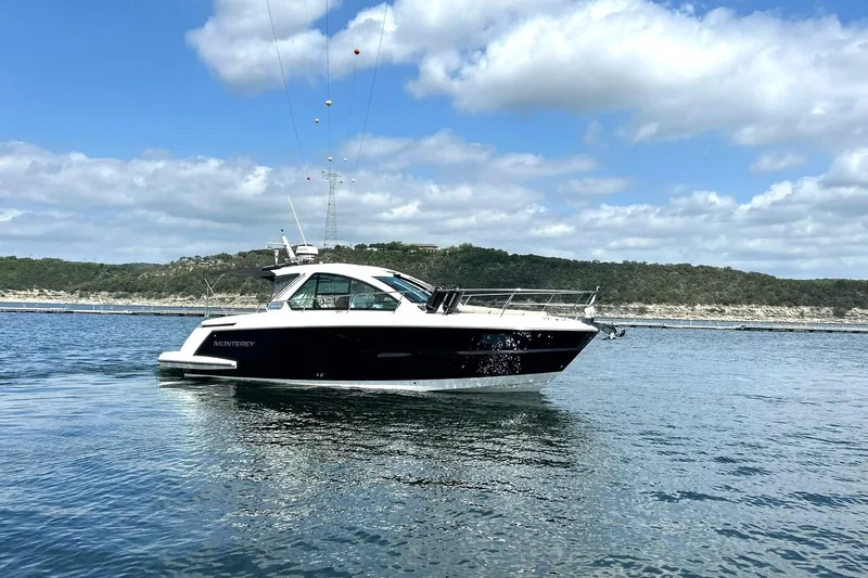 Slide: The Image of 2017 Monterey 360 Sport Coupe cruising on a scenic lake under a partly cloudy sky. - 7