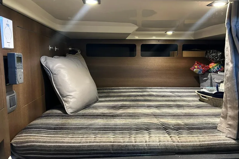 Slide: The Image of 2017 Monterey 360 Sport Coupe cabin interior with striped bedding and ambient lighting. - 71