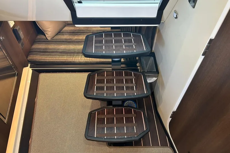 Slide: The Image of Interior of 2017 Monterey 360 Sport Coupe with wooden steps and striped seating. - 76