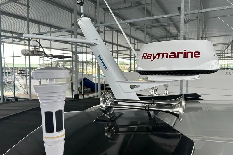 Slide: The Image of Radar and horn equipment on a 2017 Monterey 360 Sport Coupe boat in a marina. - 87