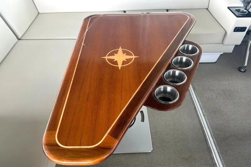 Slide: The Image of Luxury wooden table with compass design and cup holders on a 2017 Monterey 360 Sport Coupe. - 92