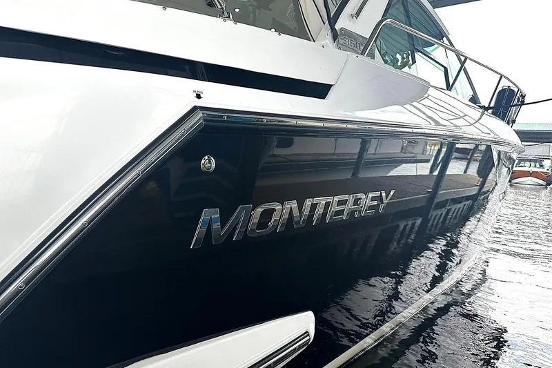 Slide: The Image of 2017 Monterey 360 Sport Coupe yacht docked, showcasing sleek design and branding. - 93