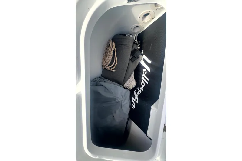 Slide: The Image of Storage compartment of 2017 Yellowfin 21 Hybrid boat with gear and rope. - 13