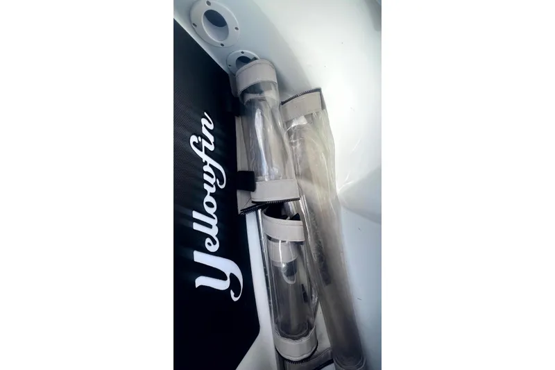 Slide: The Image of 2017 Yellowfin 21 Hybrid boat interior with storage compartments and fishing rod holders. - 14