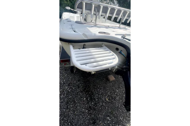 Slide: The Image of 2017 Yellowfin 21 Hybrid boat with swim platform on gravel surface. - 23