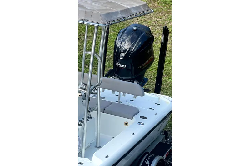 Slide: The Image of 2017 Yellowfin 21 Hybrid boat with Yamaha 250 engine, parked on grass. - 3