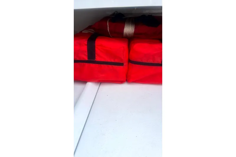 Slide: The Image of Red safety gear stored in a 2017 Yellowfin 21 Hybrid boat compartment. - 6