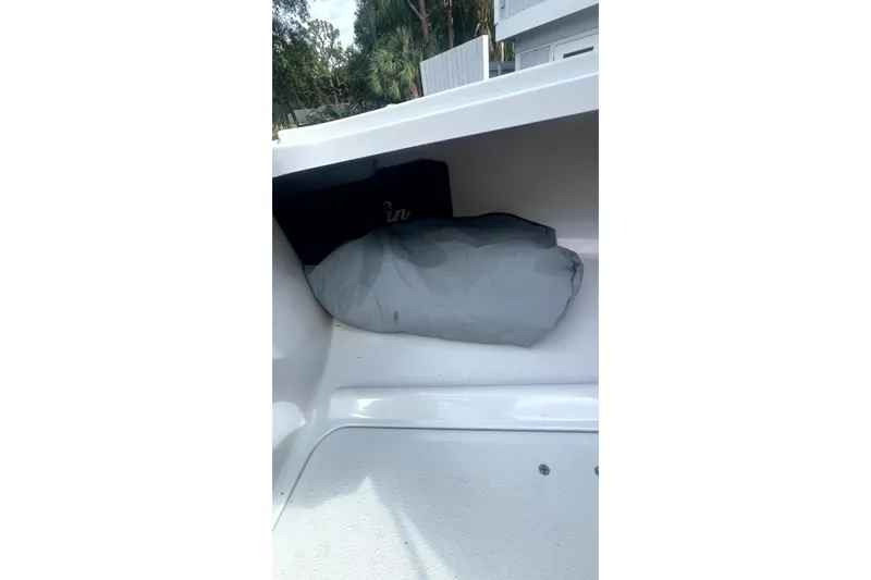 Slide: The Image of Storage compartment in a 2017 Yellowfin 21 Hybrid boat with a gray cover inside. - 8